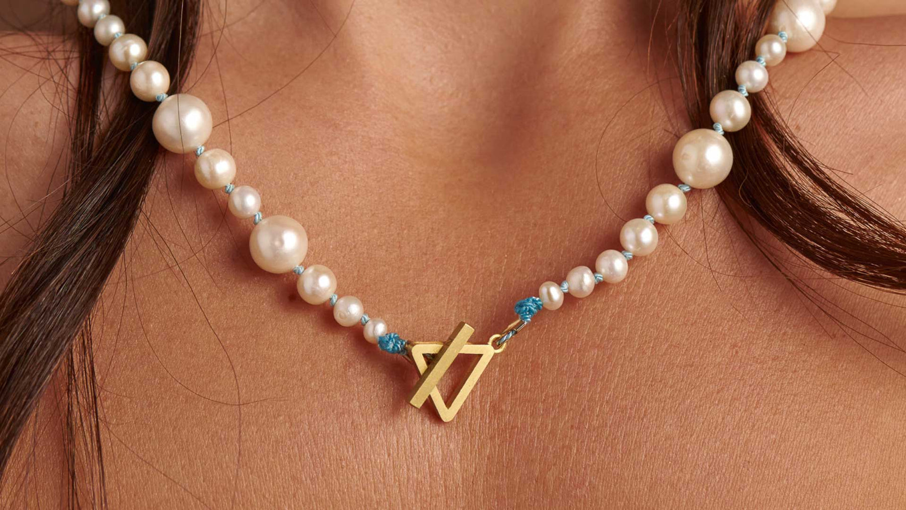 woman wearing pearl necklace closeup f zeen boutique